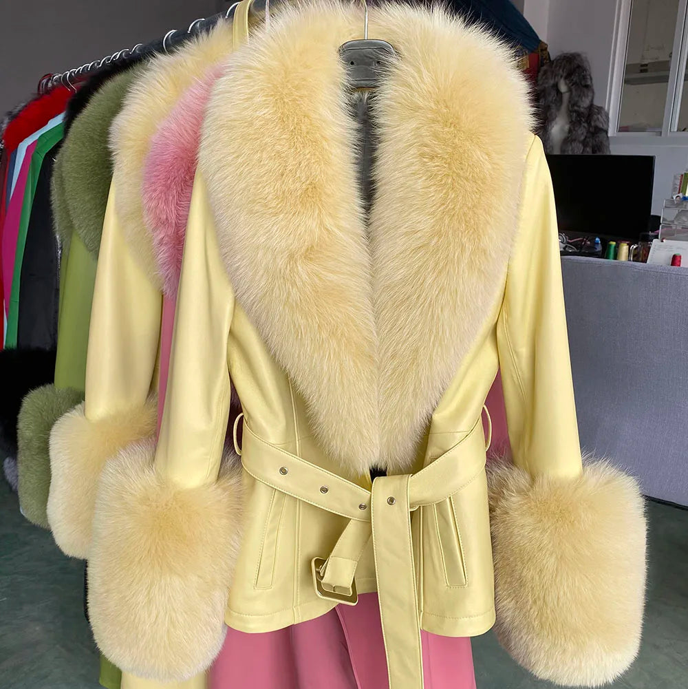 Light yellow coat with fur trim hanging on a rack.