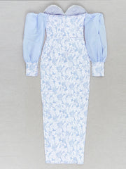 Long light blue dress with floral pattern on a gray background