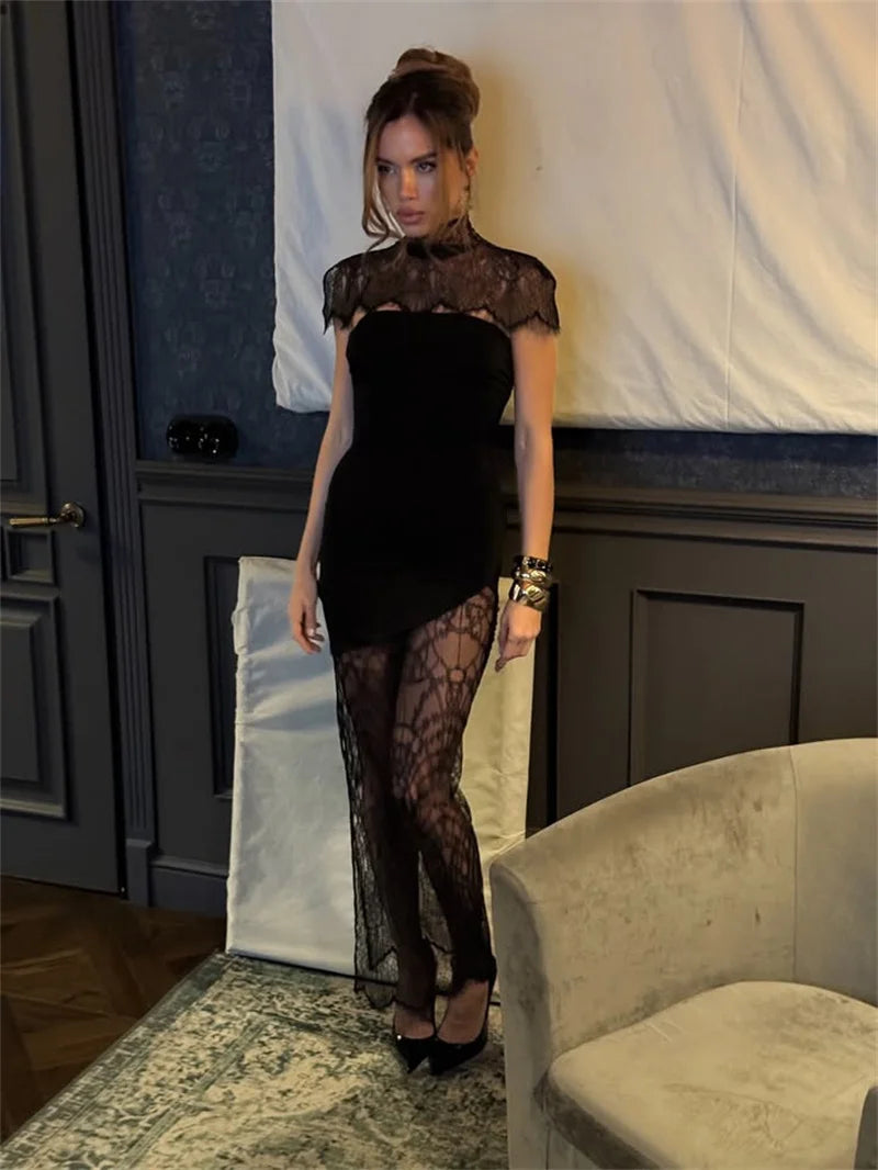 Woman wearing a black lace dress in an indoor setting