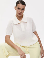 Woman wearing a white top and yellow pants on a plain background