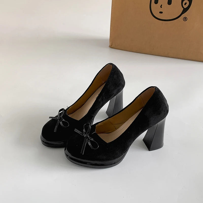 Black butterfly-knot round toe platform heels
