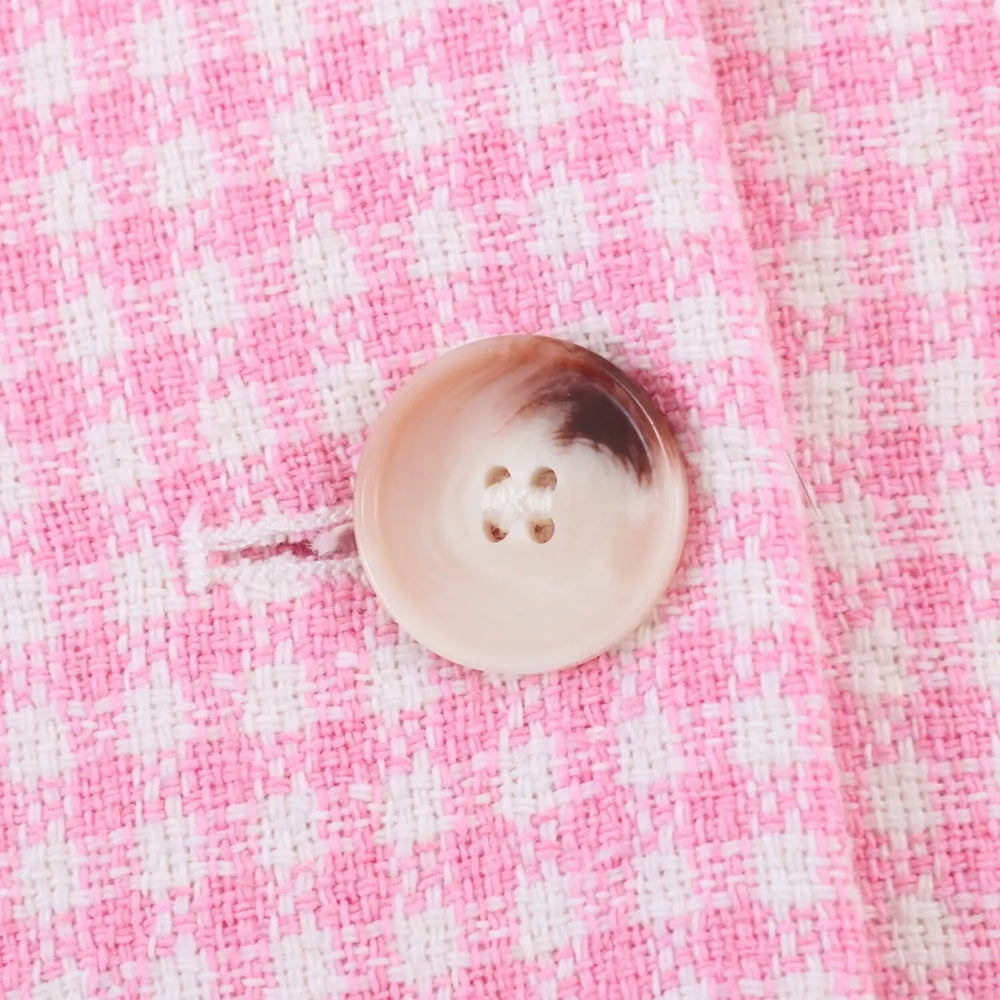 Button on a pink and white checkered fabric