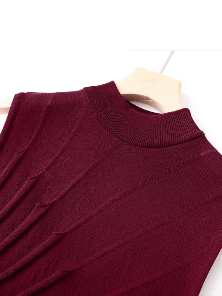 Close-up of the mock neckline and ruched texture on a maroon knit dress