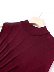 Close-up of the mock neckline and ruched texture on a maroon knit dress