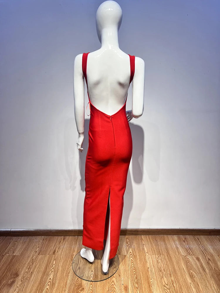 Mannequin wearing a red dress with a backless design on a wooden floor.