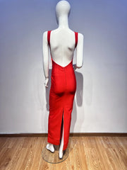 Mannequin wearing a red dress with a backless design on a wooden floor.