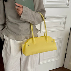 Yellow short handle tote bag with zipper closure.