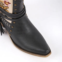 Close-up of the pointed toe on black embroidered western ankle boots.