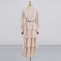 Beige lace dress on a mannequin against a plain background