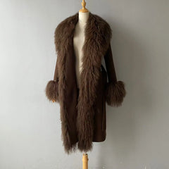 Brown fur coat on a mannequin against a plain background