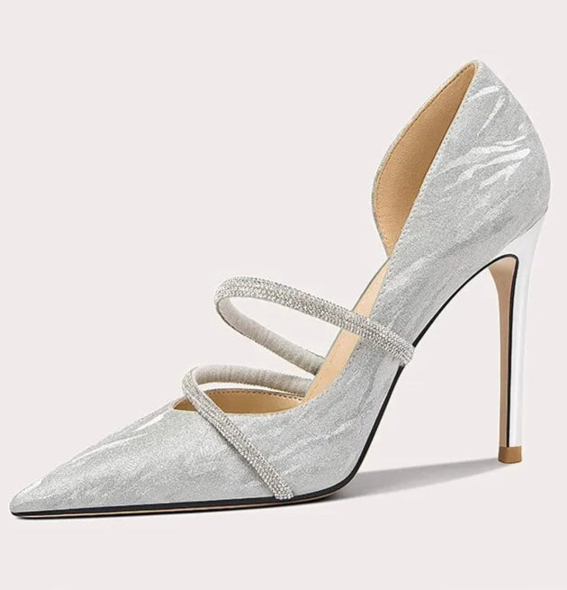 Silver high-heeled shoe with a strap on a white background