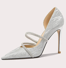 Silver high-heeled shoe with a strap on a white background
