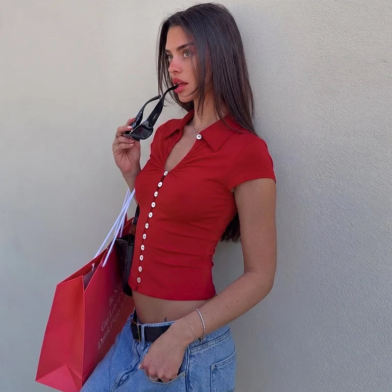 Collared button-front cutout knit top styled with jeans