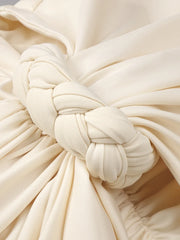 Close-up of a cream-colored fabric with a knot detail