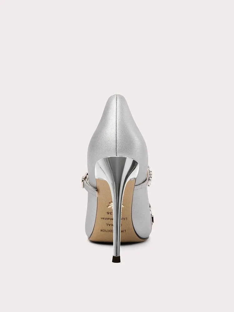 Silver high-heeled shoe on a light gray background