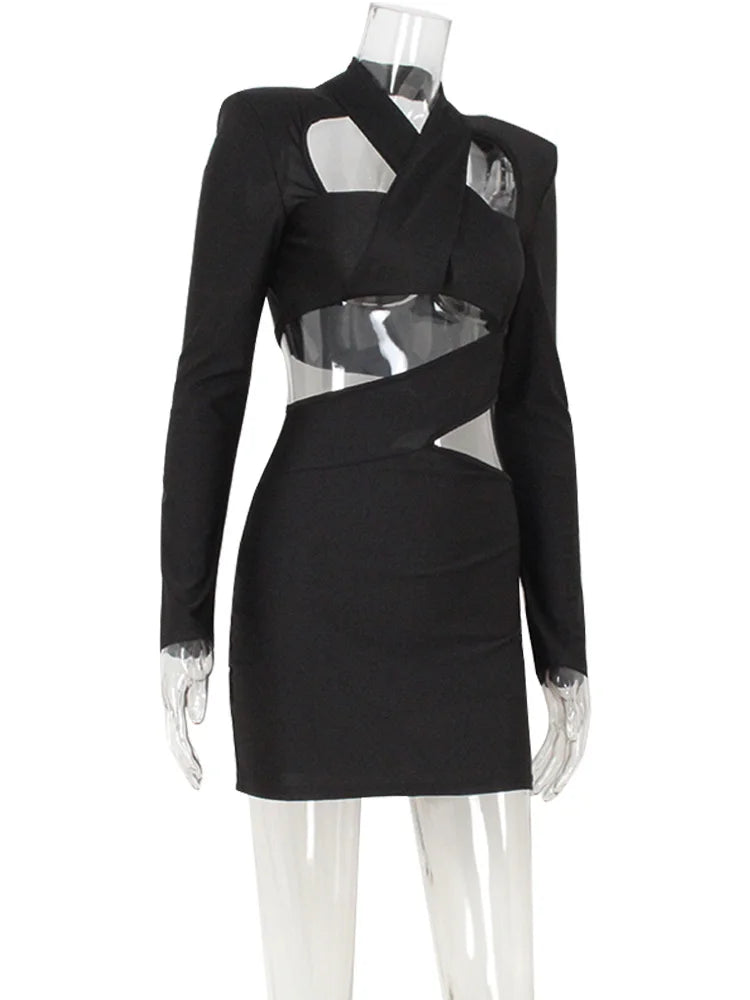 Black dress with sheer panels on a mannequin against a white background