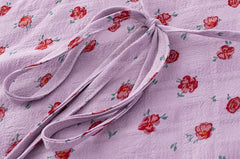 Close-up of the adjustable tie waist detail on the lilac floral midi dress