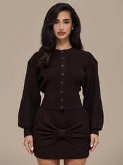 Woman wearing a dark brown knitted outfit against a beige background