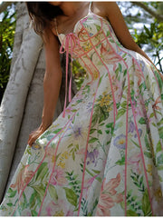 Detail of the strappy corset bustier bodice of a floral maxi dress with pink trim.
