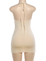Beige halter neck dress on a mannequin against a white background