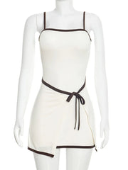 White apron with brown trim on a mannequin against a white background