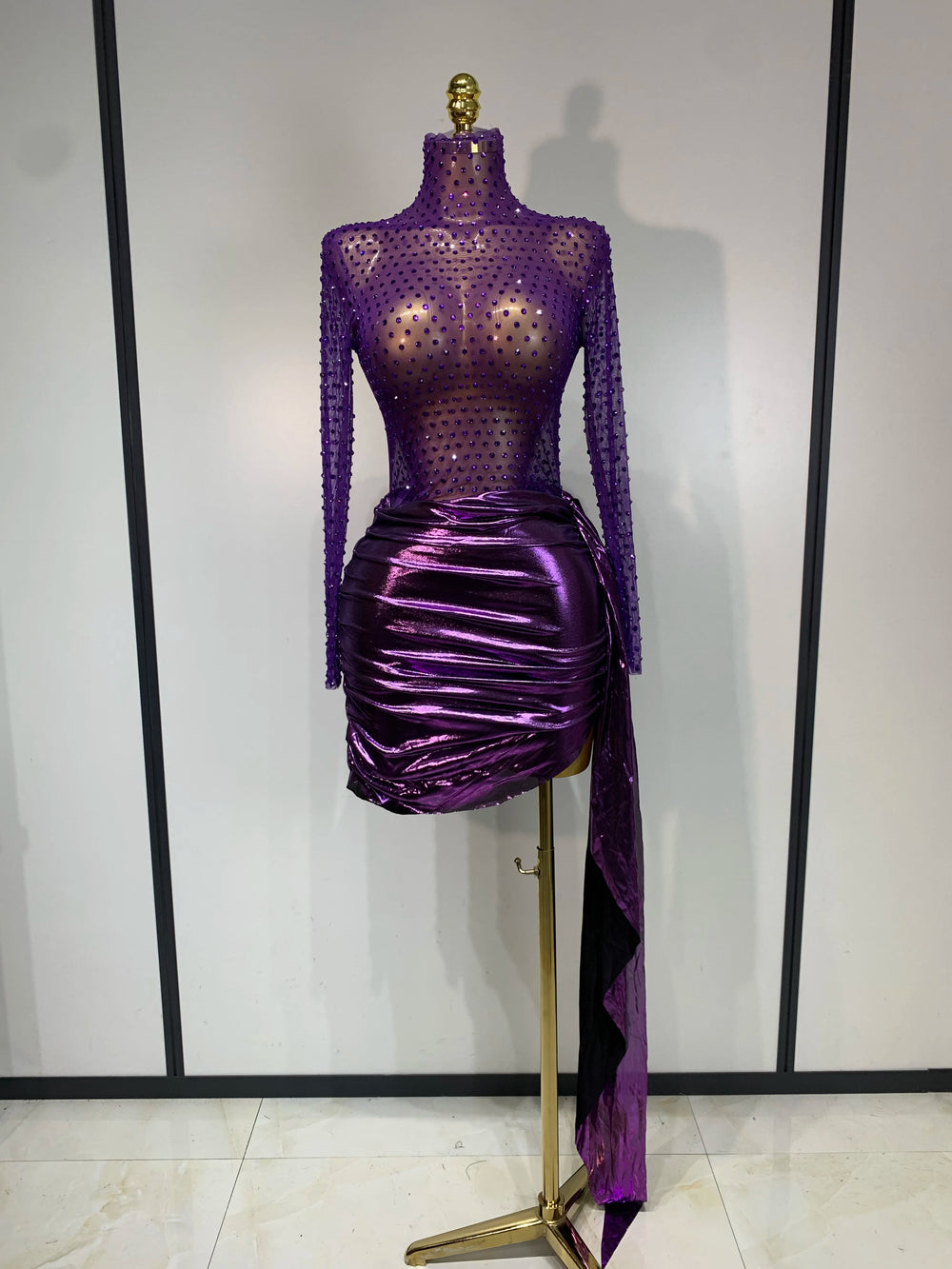 Purple long sleeve turtleneck mini dress with embellishments and draped skirt