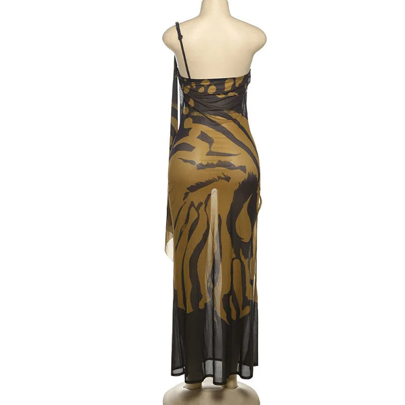 Mannequin wearing a one-shoulder dress with a black and gold pattern on a white background