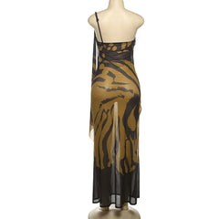 Mannequin wearing a one-shoulder dress with a black and gold pattern on a white background