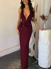 Woman wearing a burgundy evening gown in an indoor setting.