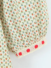 Close-up of the puff sleeve cuff with decorative trim on a mini dress.