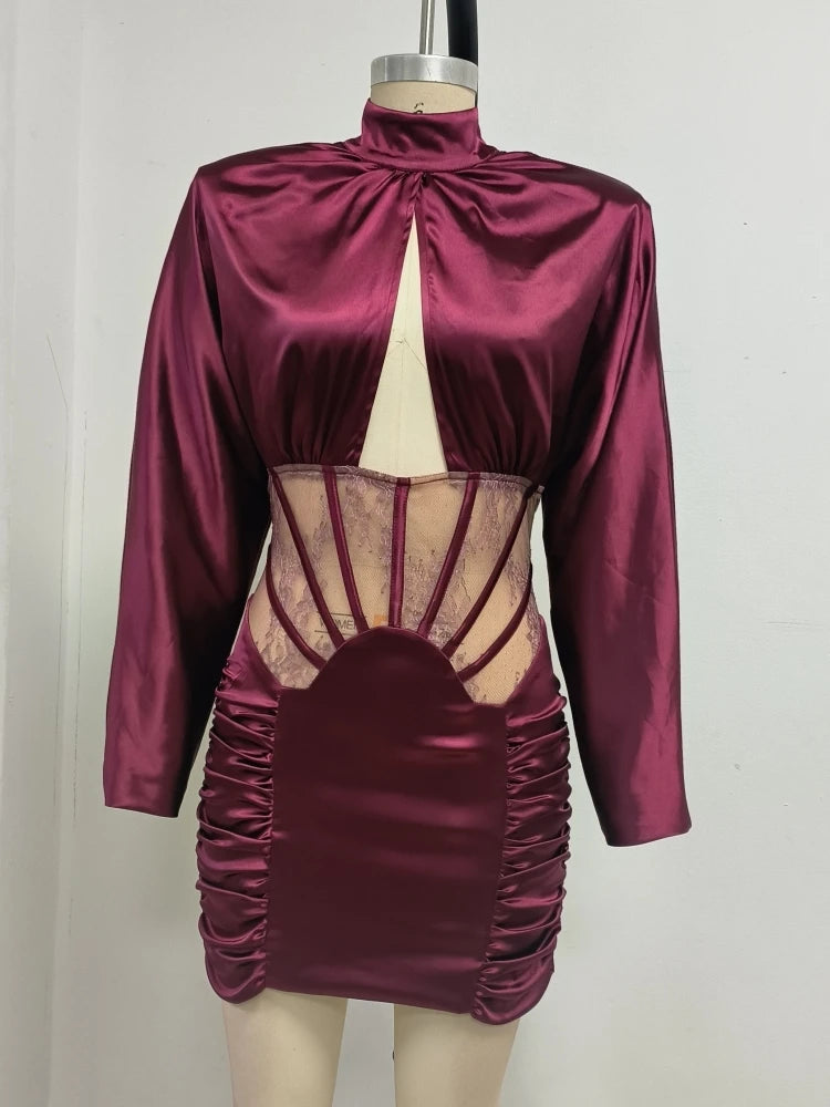 Magenta satin dress with sheer panels on a mannequin against a plain background