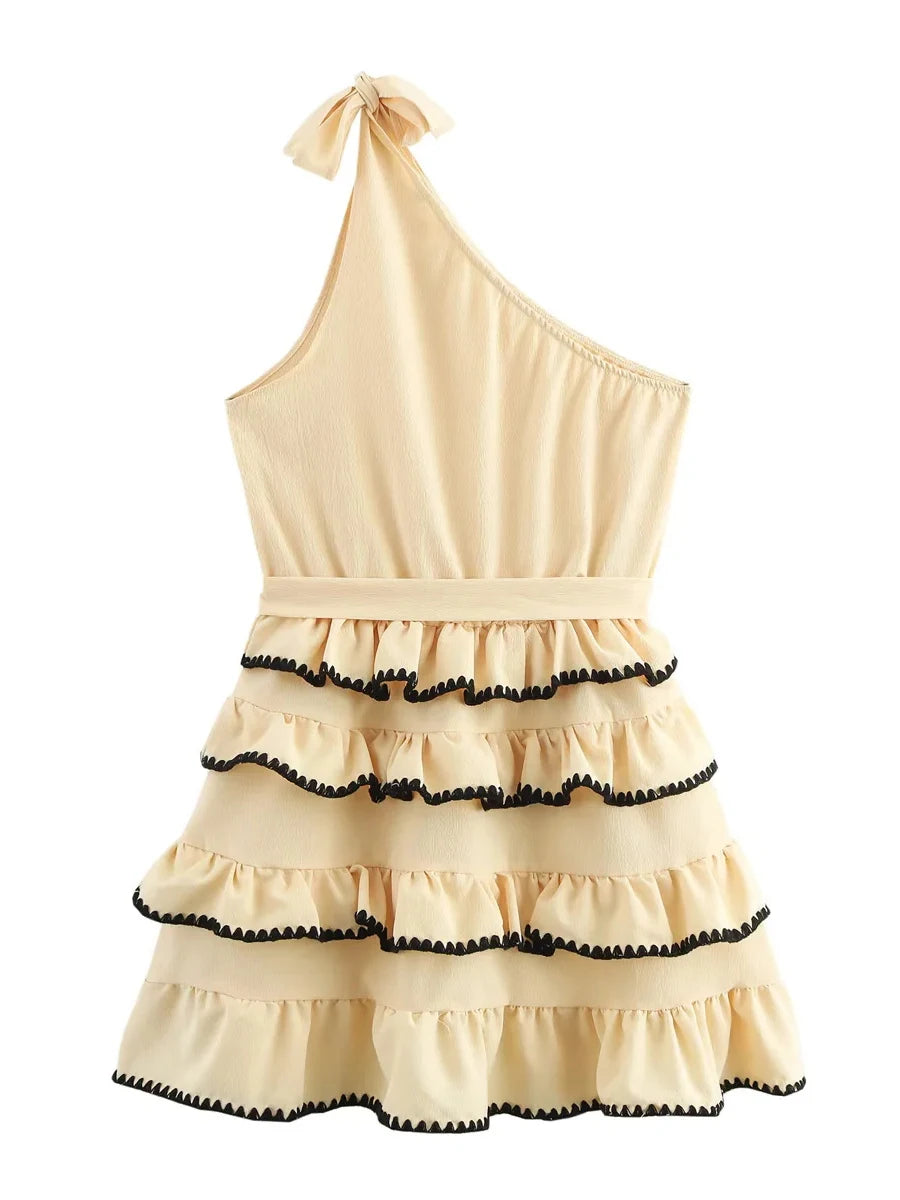 Beige one-shoulder dress with black trim on a white background