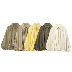 Five shirts in different colors arranged in a row on a white background