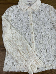 White lace blouse on a wooden surface