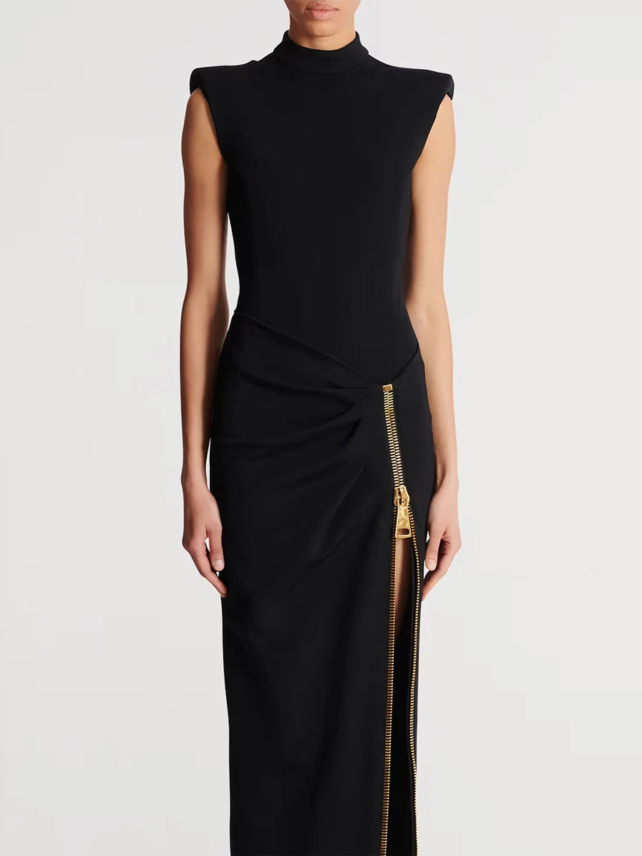 Black dress with a gold zipper on a white background