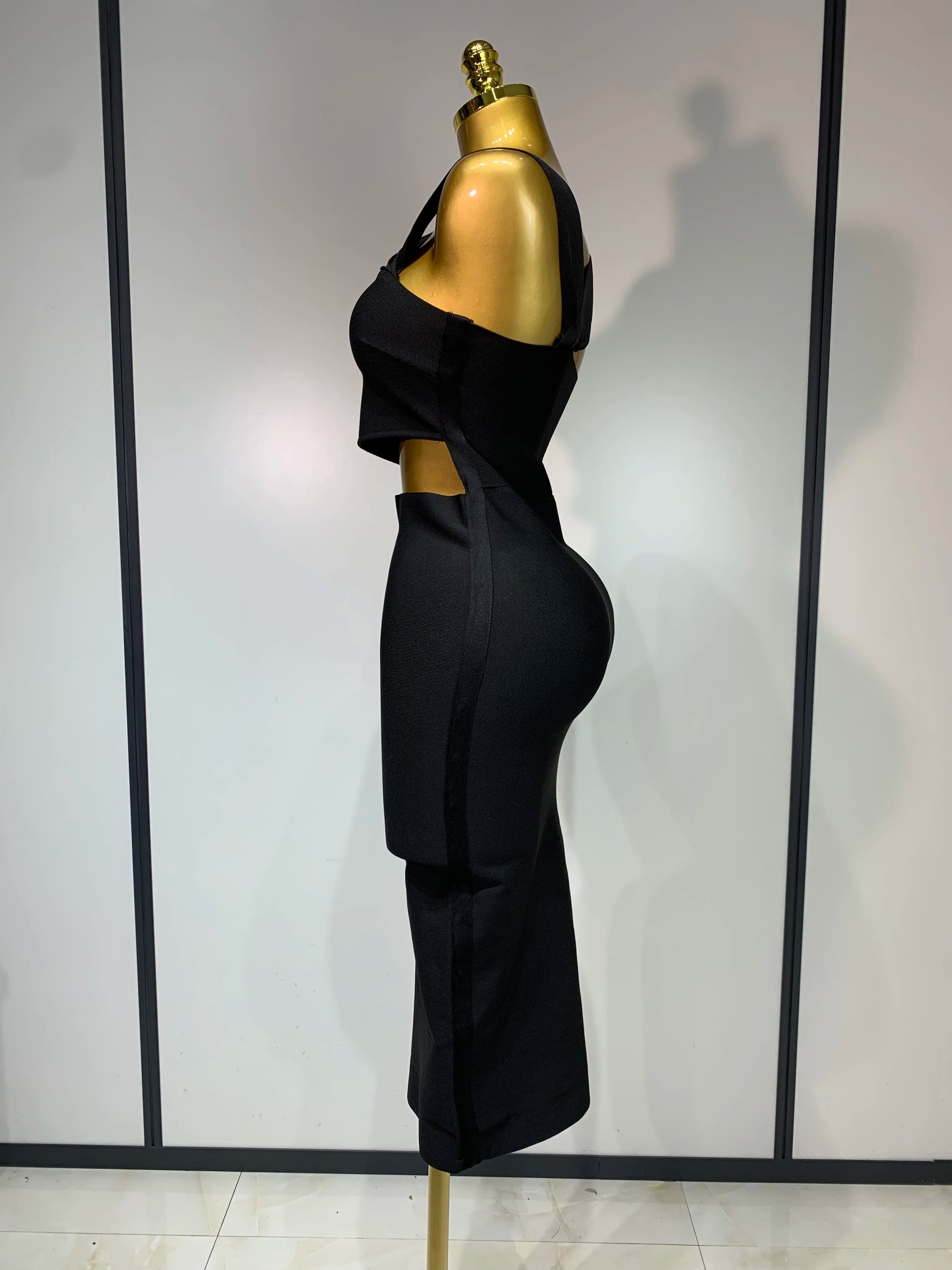 Black strapless sheath midi dress with hollow out detail.