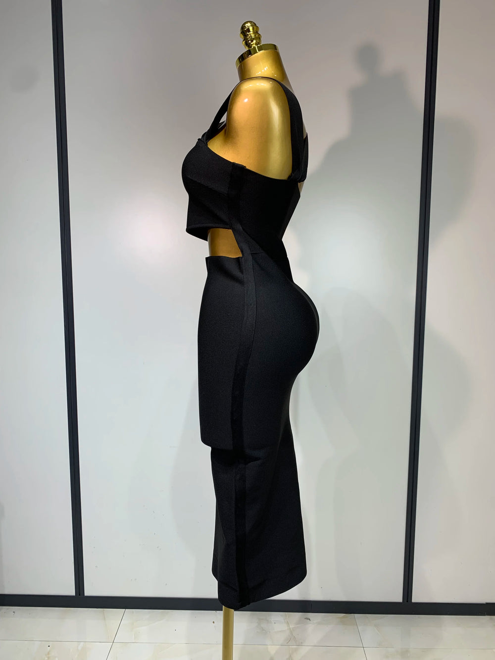 Black strapless sheath midi dress with hollow out detail.