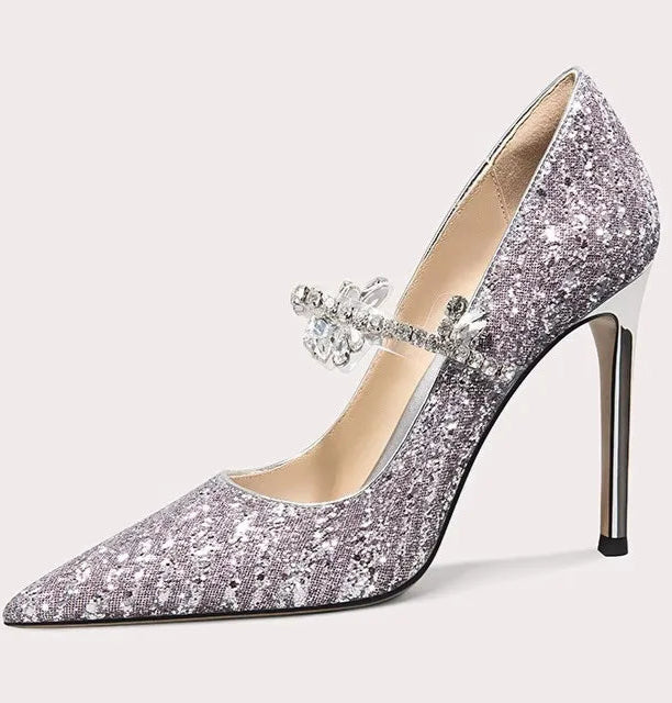 Silver glitter high-heeled shoe with a decorative bow on a white background