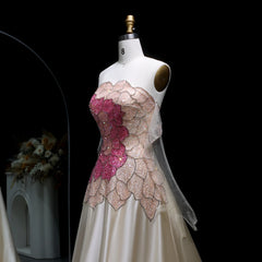 Mannequin wearing a floral dress with pink and beige flowers on a black background