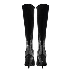 Black knee-high boots with rhinestone details on a white background
