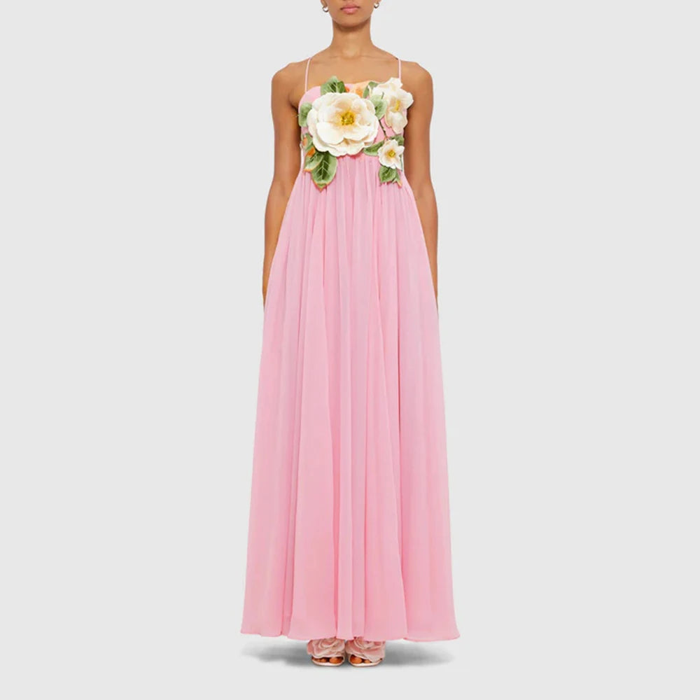 Pink dress with floral embellishments on a white background