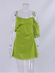 Green dress on a mannequin against a white background