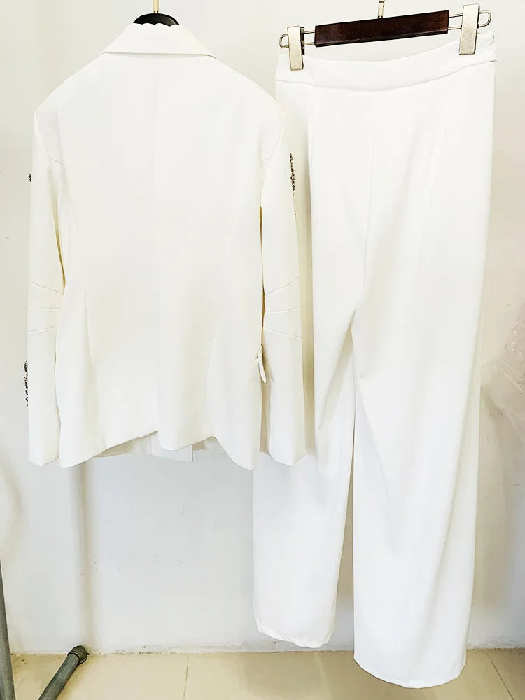 White outfit with a jacket and pants on hangers against a white background