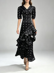 Model wearing a v-neck tiered ruffle polka dot maxi dress