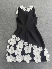 Black dress with white floral embellishments on a gray background
