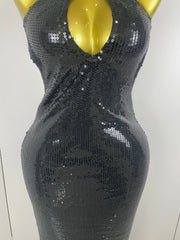 Black sequin dress on a mannequin against a white background