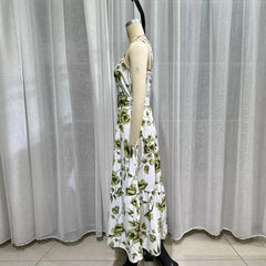 Mannequin wearing a floral dress against a white curtain background