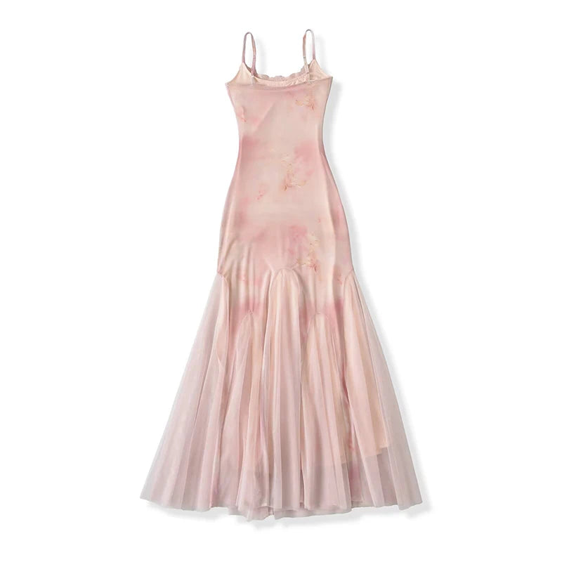 A full view of a spaghetti strap lace trim fishtail tulle gown laid flat.