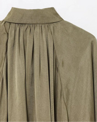 Green pleated dress on a white background