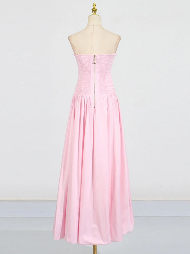 Pink strapless dress on a mannequin against a white background